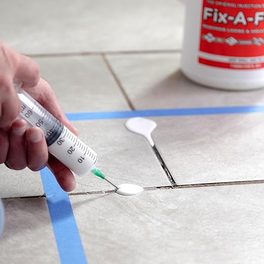 The Original Fix-A-Floor Loose Tile Repair Adhesive - Tile, Marble, Stone, Wood - Easy DIY Repair – Versatile Compatibility - 1 Gallon Jug – Comes with a Syringe Applicator